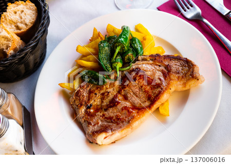 Tasty veal baked with potatoes and peppers served at plate Tasty veal baked with potatoes and peppers served at plate 137006016