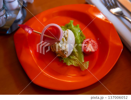 Salad for children from stuffed egg with sausage and vegetables Salad for children from stuffed egg with sausage and vegetables 137006052