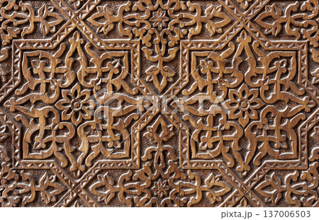 Old carved wooden panel featuring Islamic patterns Old carved wooden panel featuring Islamic patterns 137006503