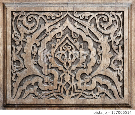 Carved wooden panel featuring intricate floral motifs Carved wooden panel featuring intricate floral motifs 137006514