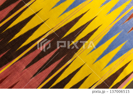 Vibrant ikat fabric featuring jagged stripes Vibrant ikat fabric featuring jagged stripes 137006515