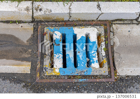 Sewer Grate Spilled Paint 137006531