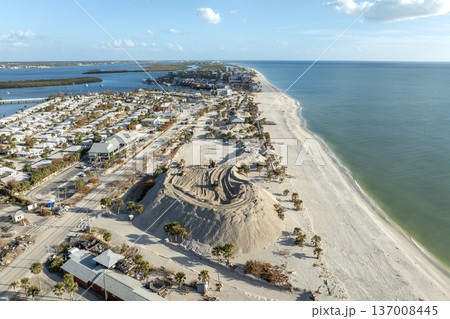 Hurricane aftermath cleanup. Piles of sand at sand recipient site on ocean shore in Florida Hurricane aftermath cleanup. Piles of sand at sand recipient site on ocean shore in Florida 137008445