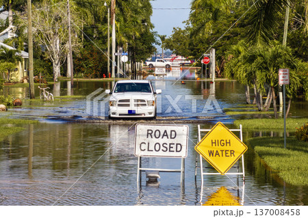 Road under water warning sign. City street closed because of flooding danger blocking driving of cars 137008458