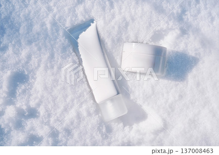 Winter skincare concept with cosmetic products on snow Winter skincare concept with cosmetic products on snow 137008463