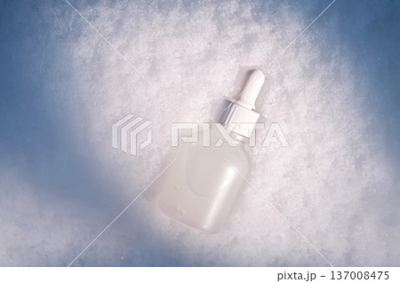 Skincare serum bottle with pipette on snow Skincare serum bottle with pipette on snow 137008475