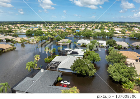 Hurricane flooded cars and homes in residential community in Florida, USA. Aftermath of natural disaster Hurricane flooded cars and homes in residential community in Florida, USA. Aftermath of natural disaster 137008500