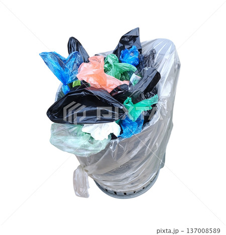 Overflowing garbage bin full of plastic waste bags 137008589