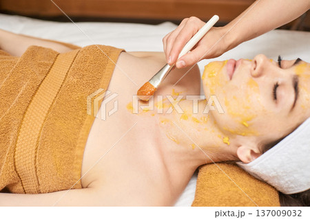 Young Caucasian Adult Female Receiving Facial Treatment With Brush In Spa Setting For Skin Young Caucasian Adult Female Receiving Facial Treatment With Brush In Spa Setting For Skin 137009032