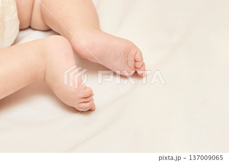 Caucasian Baby Feet On Soft White Blanket Close-Up For Parenting And Early Childhood Concepts Caucasian Baby Feet On Soft White Blanket Close-Up For Parenting And Early Childhood Concepts 137009065