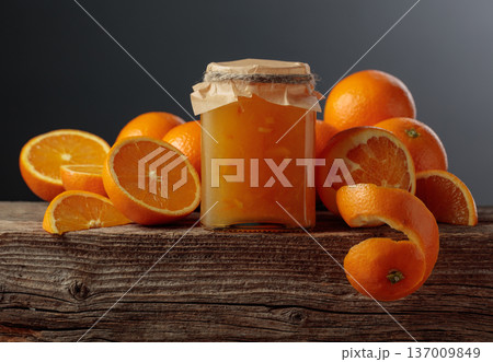 Homemade orange jam in a glass jar on on a black background. Homemade orange jam in a glass jar on on a black background. 137009849