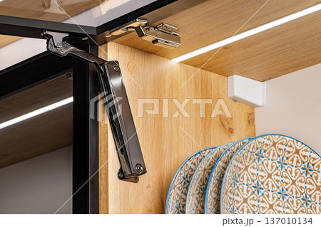 Stylish cabinet hinge enhances kitchen design with elegant dishes showcased inside Stylish cabinet hinge enhances kitchen design with elegant dishes showcased inside 137010134