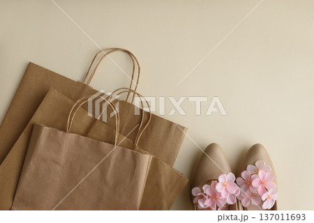 Shopping Eco Bags and Floral High Heels on Beige Background. Festive Spring Fashion Flatlay Shopping Eco Bags and Floral High Heels on Beige Background. Festive Spring Fashion Flatlay 137011693