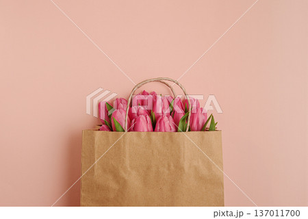 Gift Bag with Pink Tulips on Pink Background. Valentines or Mothers Day Celebration Gift Bag with Pink Tulips on Pink Background. Valentines or Mothers Day Celebration 137011700