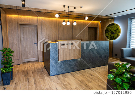 Modern hotel reception desk interior with stylish lobby design and warm lighting 137011980