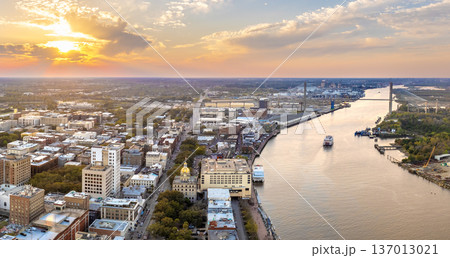 Savannah, Georgia. Famous historic River Street with waterfront tourist attractions. USA cityscape at sunset 137013021