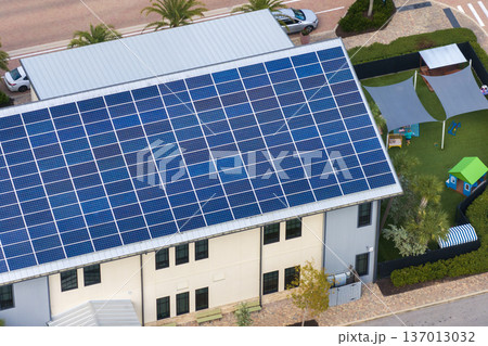 Photovoltaic panels on solar rooftop of Florida commercial building for producing clean ecological electrical energy. Renewable electricity with zero emission concept 137013032