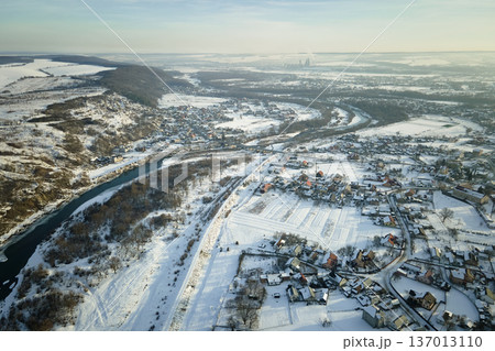 Aerial view of residential houses with snow covered roofops in suburban rural town area in winter 137013110