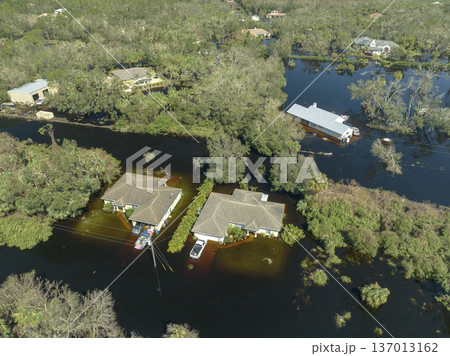 Aftermath of natural disaster. Flooded houses by hurricane Ian rainfall in Florida residential area Aftermath of natural disaster. Flooded houses by hurricane Ian rainfall in Florida residential area 137013162