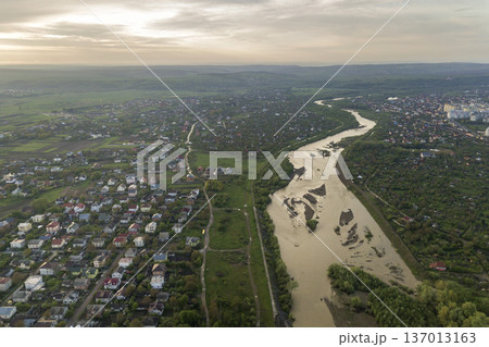 Aerial view of Ivano-Frankivsk city with residential area and suburb houses with a river in middle. Aerial view of Ivano-Frankivsk city with residential area and suburb houses with a river in middle. 137013163