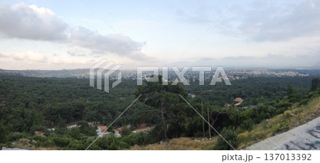 Panoramic cityscape view over forest and urban area in Antalya Turkey. Landscape geography expansion settlement horizon atmosphere and regional development concept. 137013392