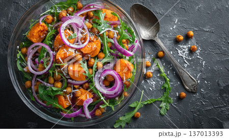 Hearty Sweet Potato and Chickpea Salad Nutritious Plant-Based Meal with Fresh Arugula, Sharp Red Onion Rings, and Parmesan Cheese on a Dark Rustic Stone Background Healthy Vegan Vegetarian Diet Hearty Sweet Potato and Chickpea Salad Nutritious Plant-Based Meal with Fresh Arugula, Sharp Red Onion Rings, and Parmesan Cheese on a Dark Rustic Stone Background Healthy Vegan Vegetarian Diet 137013393