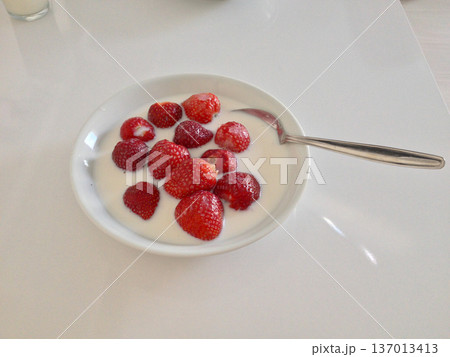 Strawberries with milk in white bowl on table. Healthy breakfast, nutrition balance and minimal lifestyle concept. 137013413