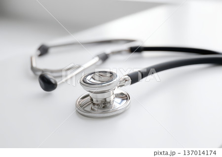 A closeup image displaying a stethoscope resting elegantly on a clean, polished surface 137014174