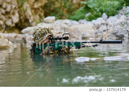 Camouflaged Sniper Soldier In Water With Scoped Rifle And Suppressor During Reconnaissance Operation Camouflaged Sniper Soldier In Water With Scoped Rifle And Suppressor During Reconnaissance Operation 137014179