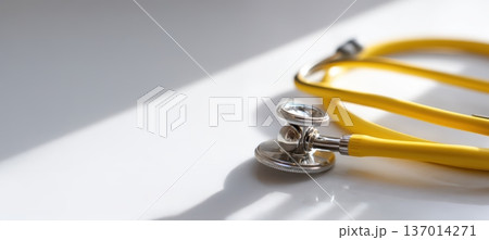 A Stethoscope on a White Surface, with Distinctive Yellow Tubing for Medical Use 137014271