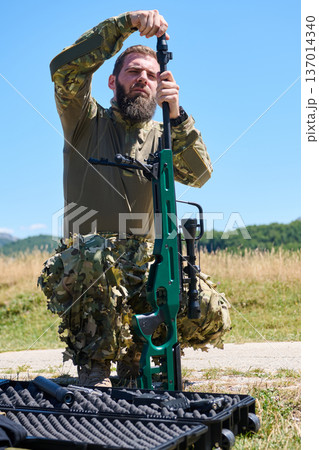 Soldier Assembling Sniper Rifle In Camouflage Uniform Outdoors During Weapons Maintenance 137014340