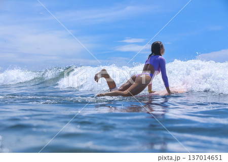 Woman Sitting On Surfboard Amid Breaking Wave Playful Beach Session Woman Sitting On Surfboard Amid Breaking Wave Playful Beach Session 137014651