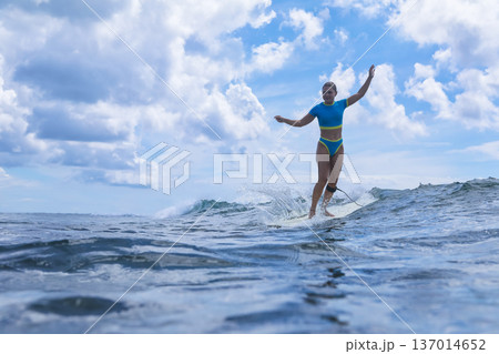 Female Instructor Showing How To Ride Waves With Enthusiasm And Movement Female Instructor Showing How To Ride Waves With Enthusiasm And Movement 137014652
