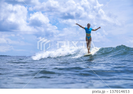 Energetic Female Surfer Demonstrates Control In Dynamic Summer Training Session 137014653
