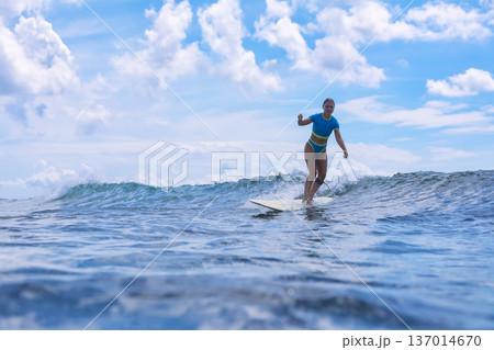 Female Surfer Merging Mindfulness With Sea Calmness And Breezes 137014670