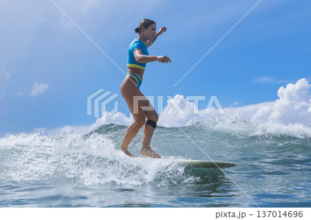 Female Wave Rider Perfects Maneuvers During Sunlit Surf Practice Session 137014696