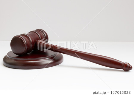 Judge's gavel hammer for adjudication isolated on white background. wooden auction hammer with a wooden stand. law and justice concept. 137015028