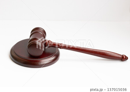 Judge's gavel hammer for adjudication isolated on white background. wooden auction hammer with a wooden stand. law and justice concept. Judge's gavel hammer for adjudication isolated on white background. wooden auction hammer with a wooden stand. law and justice concept. 137015036
