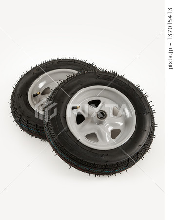 Two wheels from a garden cart on a white background. 137015413