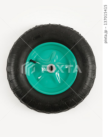 Wheel is pneumatic on a white background. Black rubber, green disc. Wheel is pneumatic on a white background. Black rubber, green disc. 137015415