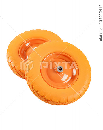 Two wheels from a garden cart on a white background. Orange rubber and disc. 137015419