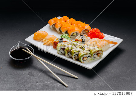 Assorted sushi set with rolls nigiri shrimp and soy sauce on restaurant plate 137015997