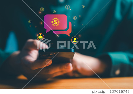 Person using a smartphone with glowing chat bubbles and money icons represents mobile banking, digital payments, financial chatbot assistance, online transactions, and modern fintech communication. Person using a smartphone with glowing chat bubbles and money icons represents mobile banking, digital payments, financial chatbot assistance, online transactions, and modern fintech communication. 137016745