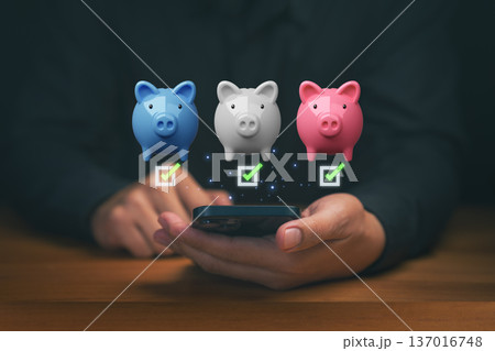 Person using a smartphone with piggy bank icons and check marks, symbolizing smart saving, financial planning, budget management, and digital money organization through modern mobile finance tools. Person using a smartphone with piggy bank icons and check marks, symbolizing smart saving, financial planning, budget management, and digital money organization through modern mobile finance tools. 137016748