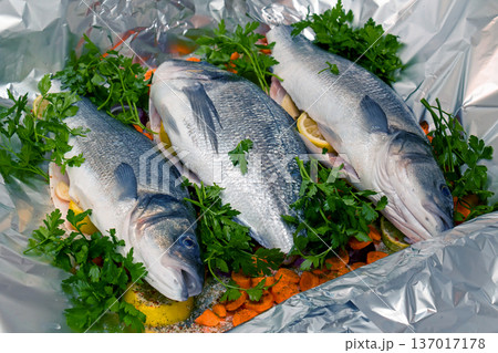 Raw  sea fish on silver foil 137017178