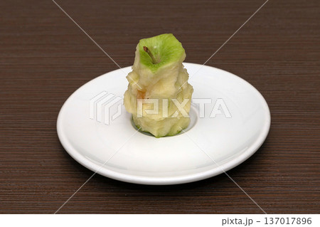 Bitten apple on a plate Bitten apple on a plate 137017896