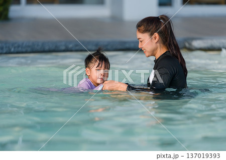 preschool child girl playing and swimming with her mother in pool preschool child girl playing and swimming with her mother in pool 137019393
