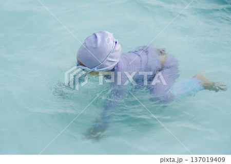 preschool child girl learning to diving in swimming pool preschool child girl learning to diving in swimming pool 137019409