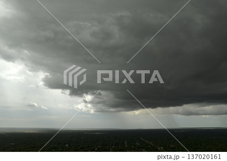 Rain shower water pouring down from stormy clouds during summer thunderstorm in rural Florida 137020161