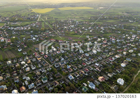 Aerial landscape of small town or village with rows of residential homes and green trees. Aerial landscape of small town or village with rows of residential homes and green trees. 137020163